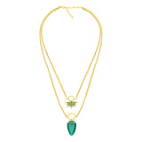 Double chain necklace adorned with emerald green stone.