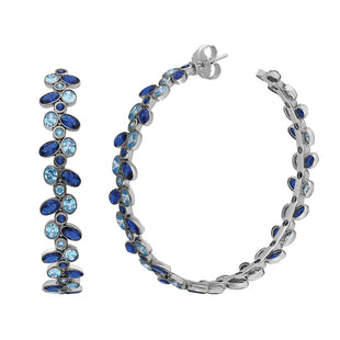Statement hoop earrings adorned with blue gemstone.